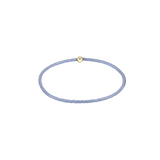 Thin blue beaded bracelet with a gold clasp on a white background. Available at Be Charmed
