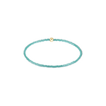 Turquoise beaded bracelet with a gold clasp on a white background. Available at Be Charmed