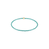 Turquoise beaded bracelet with a gold clasp on a white background. Available at Be Charmed