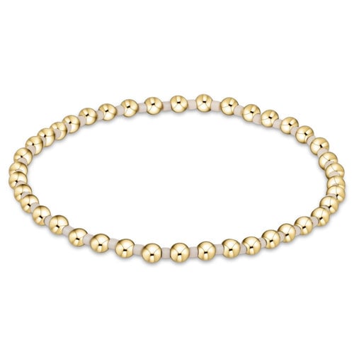 enewton Hope Grateful bracelet with off-white beads in a subtle, meaningful gratitude pattern; stretch-fit and stackable. Available at Be Charmed.