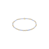 Delicate bracelet with gold and light blue beads on a white background. Available at Be Charmed