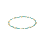 Turquoise beaded bracelet with gold accents on a white background. Available at Be Charmed