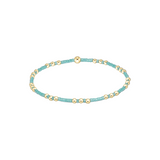 Turquoise beaded bracelet with gold accents on a white background. Available at Be Charmed