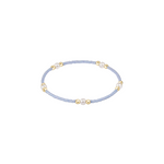 Delicate bracelet with small beads on a light blue cord against a white background. Available at Be Charmed