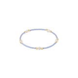 Delicate bracelet with small beads on a light blue cord against a white background. Available at Be Charmed