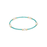 Turquoise beaded bracelet with pearls and gold accents on a white background. Available at Be Charmed