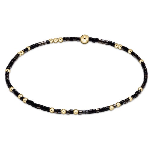 A bracelet with black onyx beads and gold-filled beads, featuring a mixed-color design. Available at Be Charmed