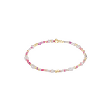 Beaded bracelet with pink, gold, and white beads on a white background. Available at Be Charmed
