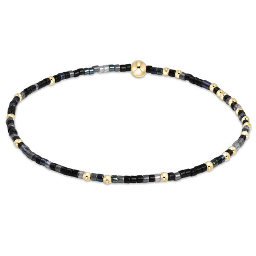 enewton Hope Unwritten bracelet in “Nothin’ Good After Midnight” dark tones; bold, moody, and stretch-fit. Available at Be Charmed.