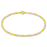 A bracelet with yellow and gold-filled beads on a high-performance elastic band. Available at Be Charmed