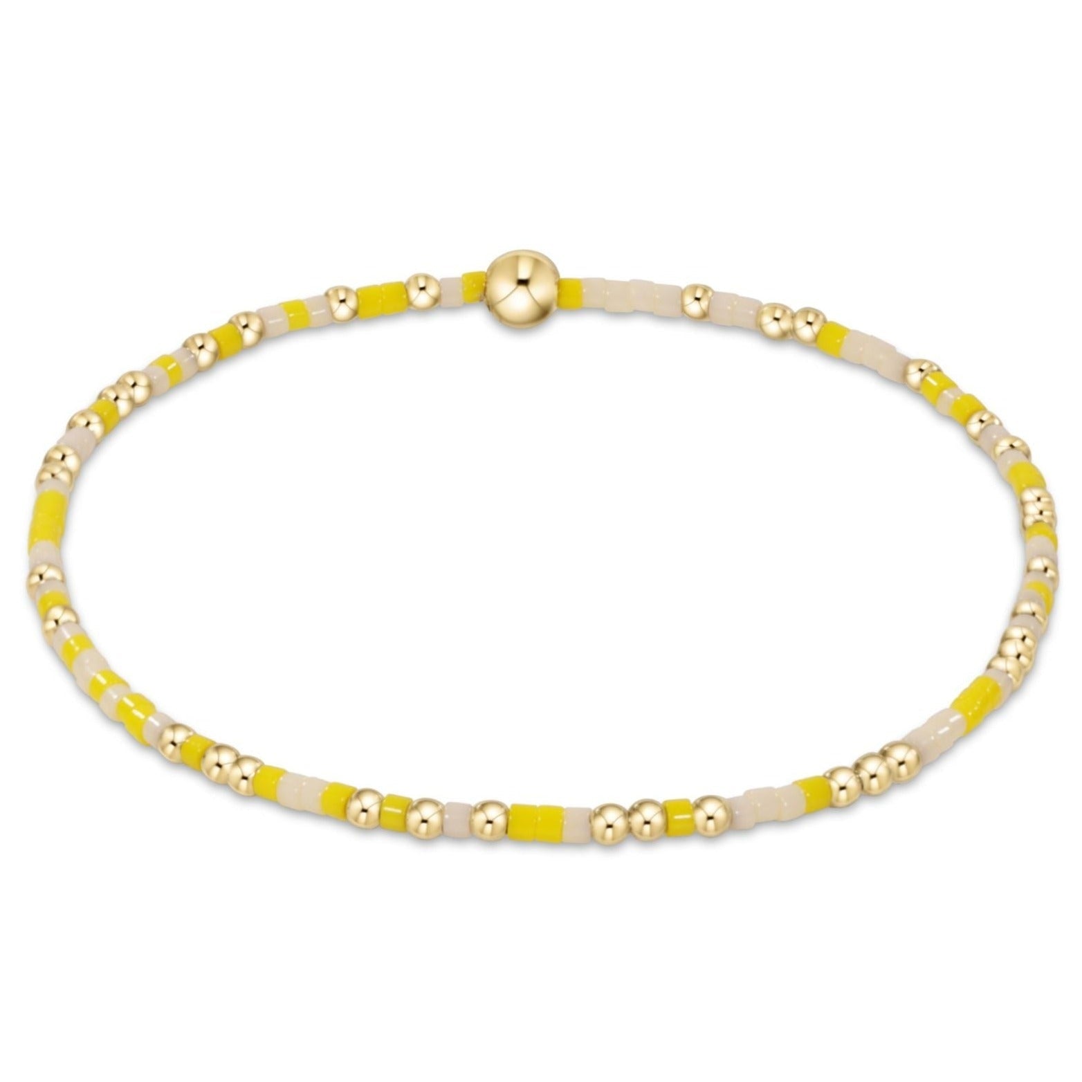 A bracelet with yellow and gold-filled beads on a high-performance elastic band. Available at Be Charmed