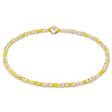 A bracelet with yellow and gold-filled beads on a high-performance elastic band. Available at Be Charmed