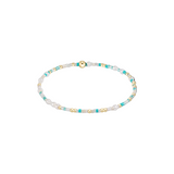 Beaded bracelet with turquoise, gold, and white beads on a white background. Available at Be Charmed