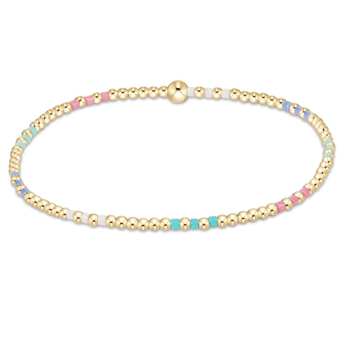 enewton Hope Joy Pattern 2mm Bead Bracelet – Hot Mess SS25 – featuring pastel pink, blue, and purple 2mm seed beads with 2mm 14kt gold‑filled beads on stretch elastic. Worry‑free wear—safe for sleep, shower, and sweat. Stackable and stylish. Available at Be Charmed