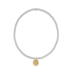 A sterling silver bracelet with gold accents featuring 2mm beads and a small gold charm. Available at Be Charmed