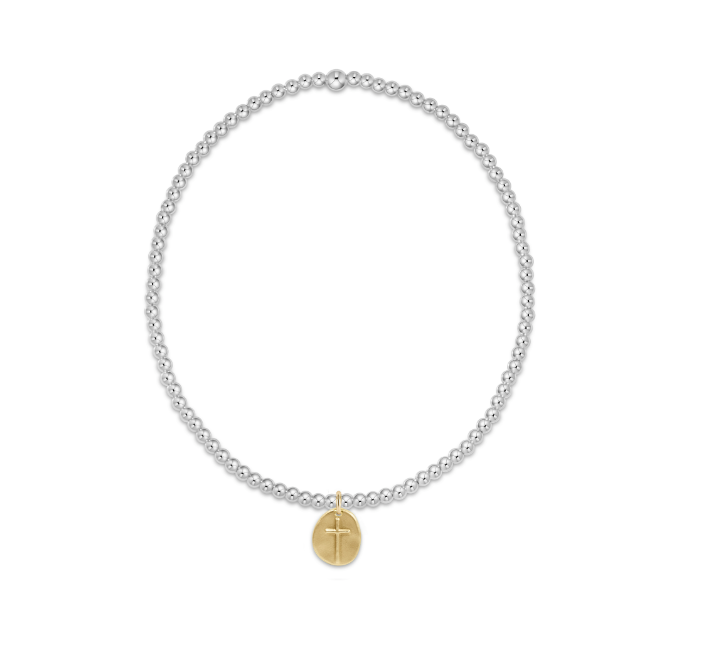 A sterling silver bracelet with gold accents featuring 2mm beads and a small gold charm. Available at Be Charmed