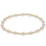 Pearl Classic Sincerity Pattern 4mm Bead Bracelet by enewton with alternating gold-filled and pearl beads on stretch cord—elegant and stackable; available at Be Charmed