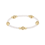 Pearl and gold bracelet on a white background. Available at Be Charmed