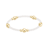 Bracelet with alternating gold and pearl beads on a white background. Available at Be Charmed