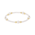 Pearl bracelet with gold beads on a white background. Available at Be Charmed