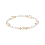 Pearl bracelet with gold beads on a white background. Available at Be Charmed