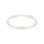 Pearl bracelet with gold accents on a white background. Available at Be Charmed