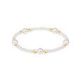 Pearl bracelet with gold accents on a white background. Available at Be Charmed