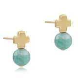 A pair of 14k gold-filled cross stud earrings with blue gemstones. Available at Be charmed
