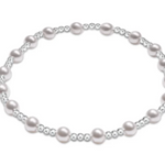 An enewton Sterling Silver bracelet featuring 4mm pearl beads and 2mm Sterling Silver beads, hand-strung on elastic for slight stretch.