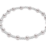 An enewton Sterling Silver bracelet featuring 4mm pearl beads and 2mm Sterling Silver beads, hand-strung on elastic for slight stretch.