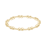 Gold beaded bracelet on a white background. Available at Be Charmed