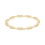 Gold beaded bracelet on a white background. Available at Be Charmed