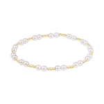 Pearl bracelet with gold accents on a white background. Available at Be Charmed