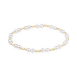 Pearl bracelet with gold accents on a white background. Available at Be Charmed