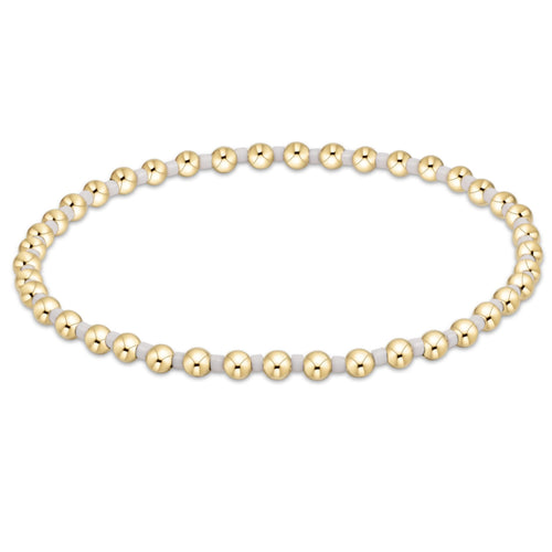 enewton Hope Grateful Bracelet – white 2mm seed beads alternating with 2mm 14kt gold-filled beads on stretch elastic. Worry-free wear—sleep, shower, sweat. Stackable elegance. Available at Be Charmed