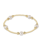 Enewton purpose dignity gold bracelet with pearls on a white background. Avaiable at Be Charmed