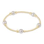 Gold and pearl bracelet on a white background. Available at Be Charmed