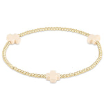 enewton Gold bracelet with off white cross charms on a white background. Available at Be Charmed