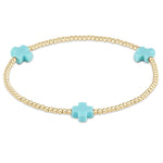 enewton Bracelet with gold beads and turquoise cross-shaped charms on a white background. Available at Be Charmed