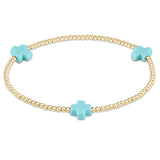 enewton Bracelet with gold beads and turquoise cross-shaped charms on a white background. Available at Be Charmed