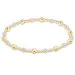 An enewton gold-colored bracelet with a pattern of gold-filled beads and white pearls, designed for stacking. Available at Be Charmed