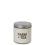 Candle jar with 'Farm + Sea' branding on a white background. Available at Be Charmed