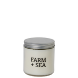 Candle jar with 'Farm + Sea' branding on a white background. Available at Be Charmed