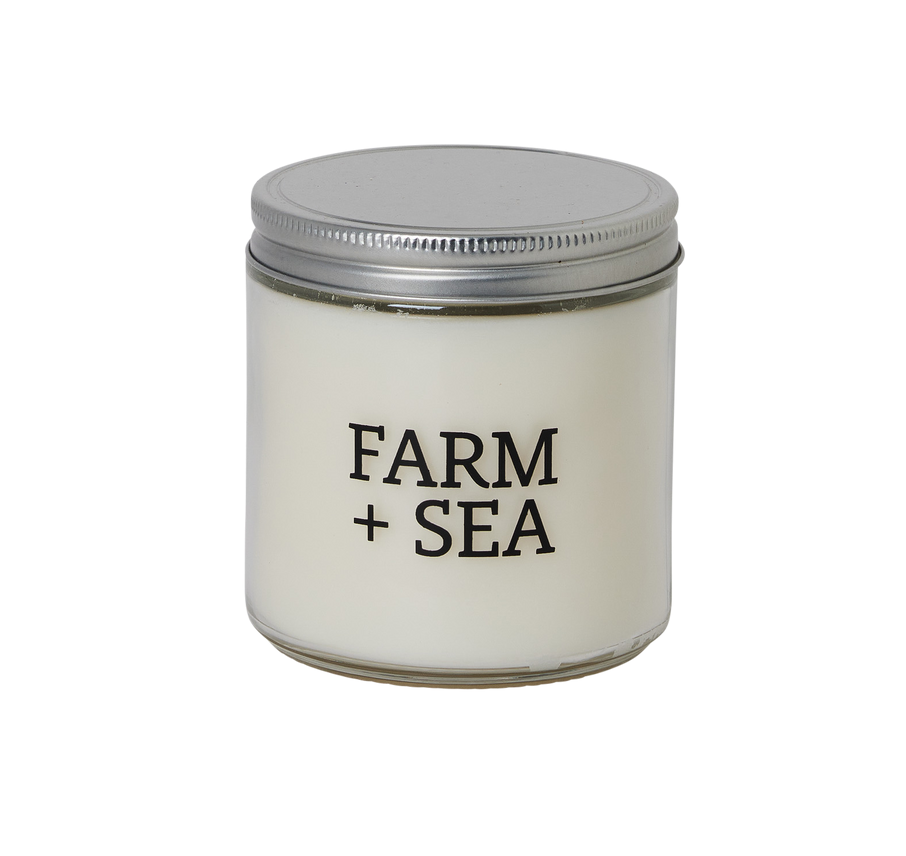 Candle jar with 'Farm + Sea' branding on a white background. Available at Be Charmed