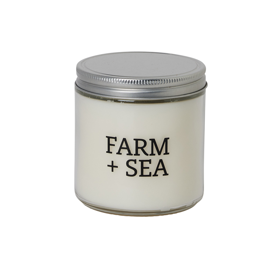 Candle jar with 'Farm + Sea' branding on a white background. Available at Be Charmed