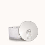 Thymes Frasier Fir Flocked 3-Wick Poured Candle with festive pine fragrance and decorative flocked exterior. Available at Be Charmed.