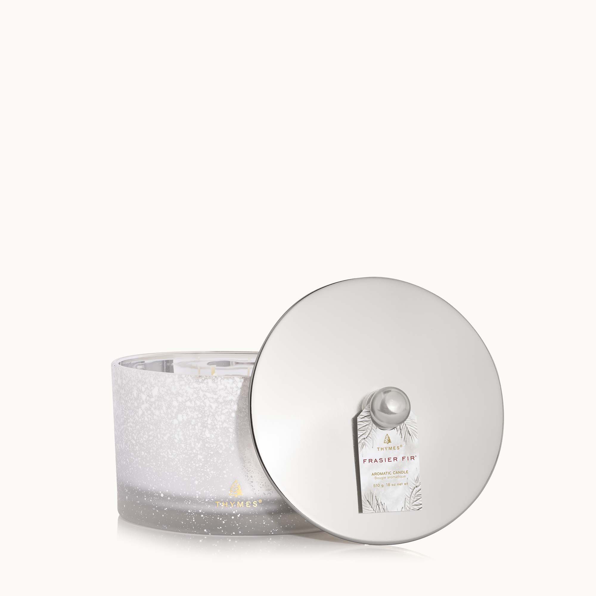 Thymes Frasier Fir Flocked 3-Wick Poured Candle with festive pine fragrance and decorative flocked exterior. Available at Be Charmed.