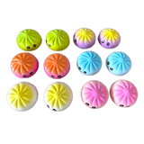 Variety of squish dumplings with faces on a white background. Available at Be Charmed