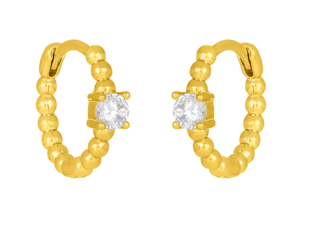 A pair of gold-plated 925 sterling silver huggie earrings with a hypoallergenic design and a central clear gemstone. Available at Be Charmed