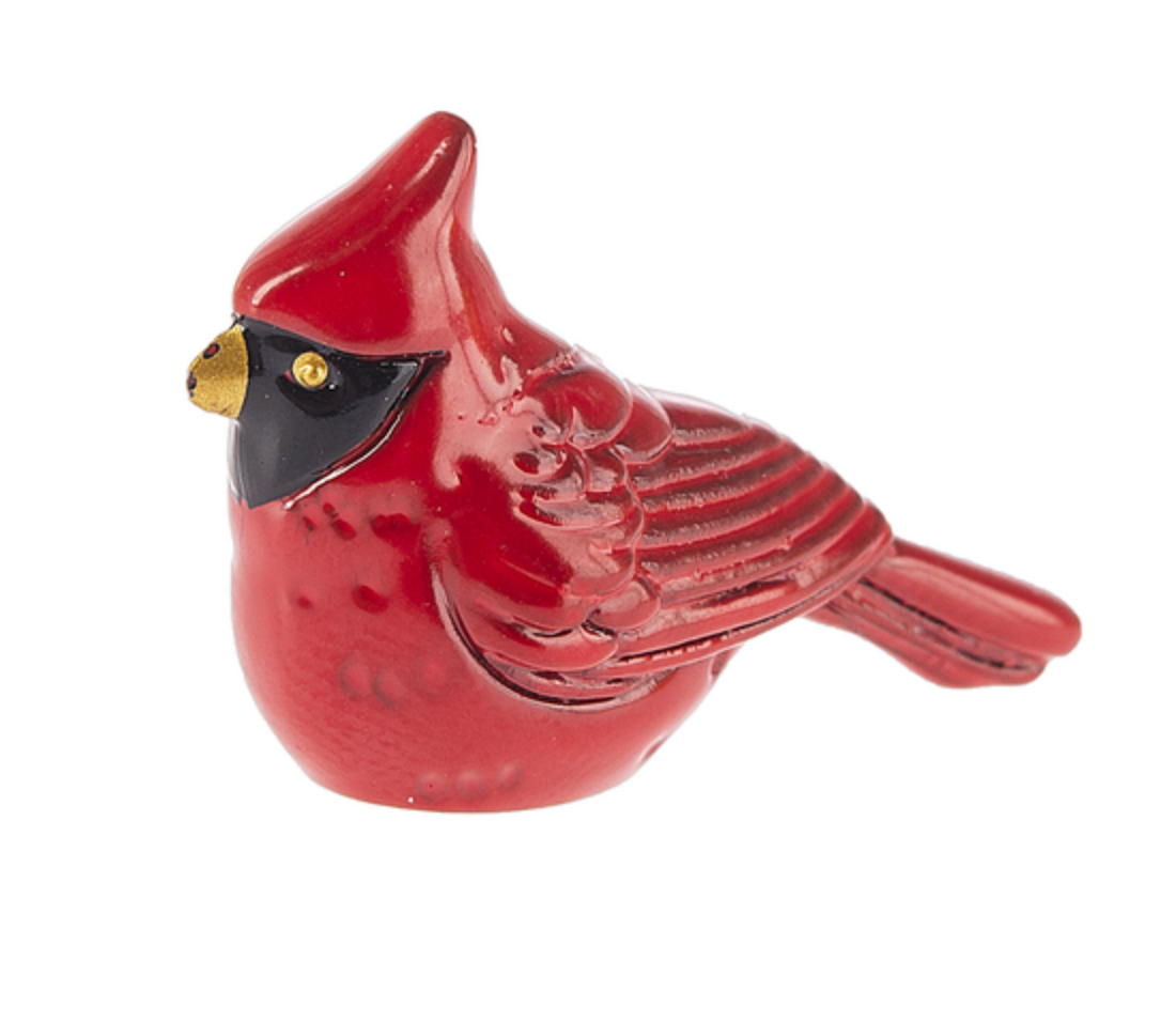 Ganz Charm A small red cardinal figurine with a glossy red finish, black eye patch, and gold beak, shown on a plain white background. Available at Be Charmed
